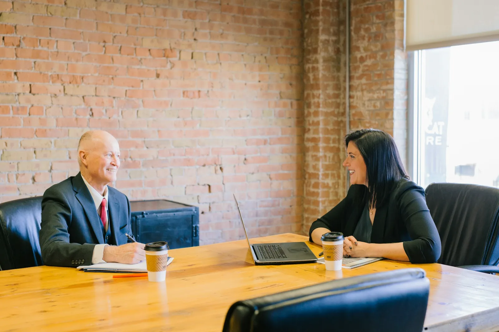 Attorney and client discussing a dealership matter